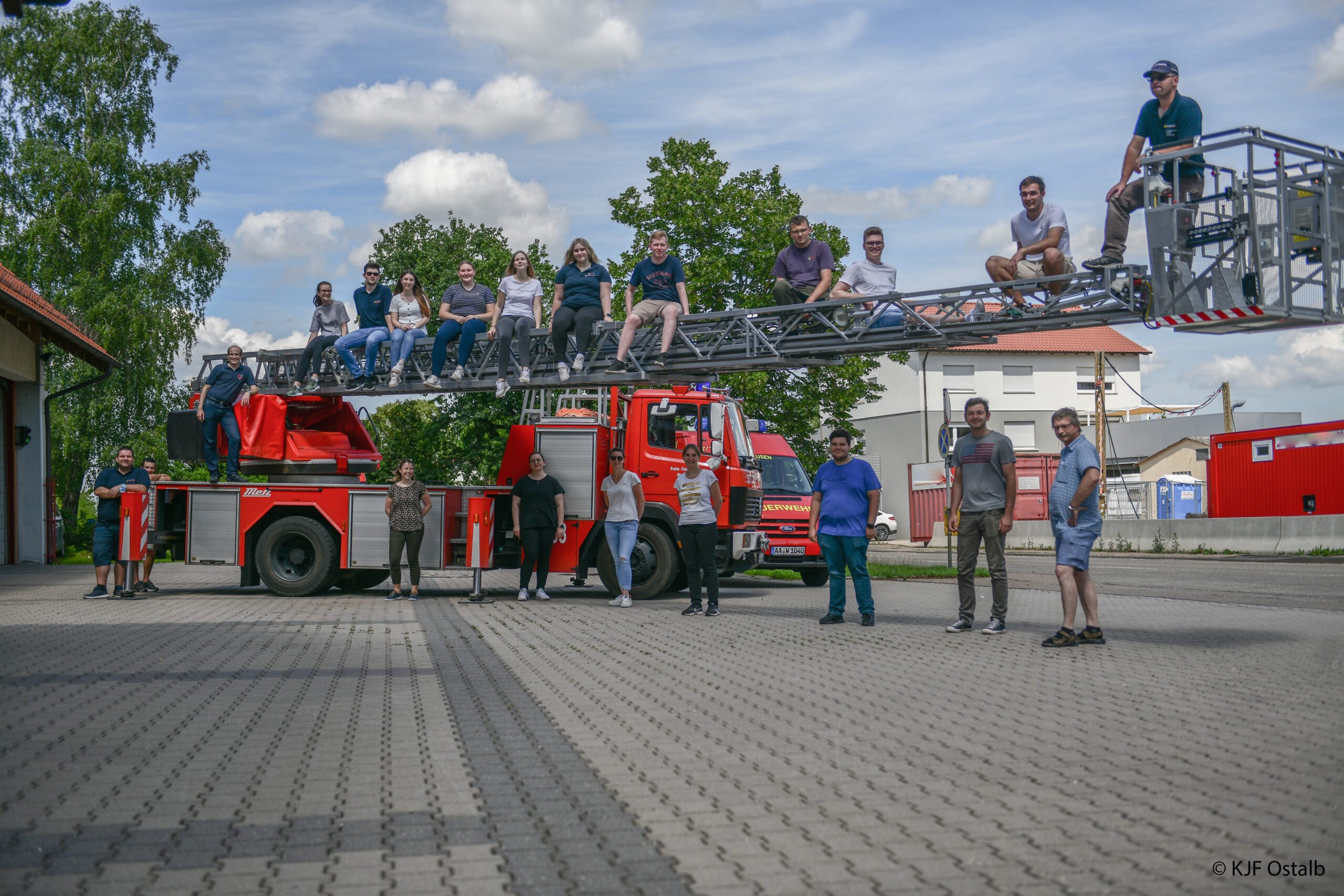 17 frisch gebackenen Jugendgruppenleiter und ihre Ausbilder vor der Drehleiter der Heubacher Feuerwehr.